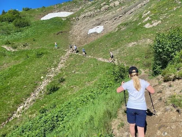 Berghang mit einem querenden Wanderpfad und Menschen, die diesen Bewandern | © DAV Pfronten - Familiengruppe